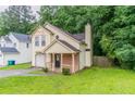 Charming two-story home with a front porch and manicured lawn, nestled in a serene neighborhood at 847 Ashley Ln, Stone Mountain, GA 30087