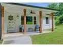 Inviting covered front porch features wooden posts and seating, a perfect spot to relax and enjoy the outdoors at 1740 Dodson Sw Dr, Atlanta, GA 30311