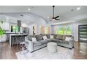 Bright living room showcases a modern design, hardwood floors, and transitions into a kitchen with stainless steel appliances at 1740 Dodson Sw Dr, Atlanta, GA 30311