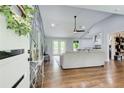 Open-concept living area with hardwood floors, vaulted ceilings, seamlessly connecting to the kitchen and dining spaces at 1740 Dodson Sw Dr, Atlanta, GA 30311