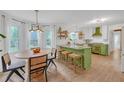 Bright and airy kitchen showcasing an island with barstool seating and stylish green cabinetry at 201 Tweed Ct, Sugar Hill, GA 30518