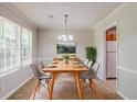 Bright dining room with neutral walls and trim, wood furniture, and natural lighting at 9119 Woodgreen Way, Jonesboro, GA 30238