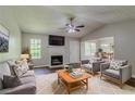 Cozy living room featuring a fireplace, plush seating, and great natural lighting at 9119 Woodgreen Way, Jonesboro, GA 30238