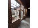 Interior view looking out to a brick courtyard with a white entry door through a large window at 320 Martin Luther King Jr Dr # 5, Atlanta, GA 30312