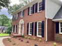A classic brick home showcasing updated landscaping and charming architectural details at 3243 Northbrook Dr, Atlanta, GA 30341