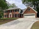 Charming red brick home with a large driveway and attached two-car garage at 3243 Northbrook Dr, Atlanta, GA 30341