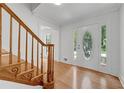 Bright foyer with hardwood floors, decorative trim, and staircase with wood banister at 3243 Northbrook Dr, Atlanta, GA 30341