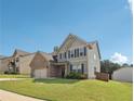 Landscaped front lawn leads to a two-story home with a brick facade and welcoming curb appeal at 4172 Cedar Commons Way, Conley, GA 30288