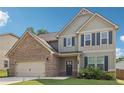 Charming two-story home with a brick and siding exterior, complemented by blue shutters and lush landscaping at 4172 Cedar Commons Way, Conley, GA 30288