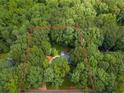 Aerial view of property in a wooded area, highlighted by a property line at 120 Majesty Ln, Fayetteville, GA 30215