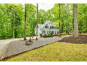 Exterior view of home highlighting its well-maintained facade, landscaping, and circular driveway at 120 Majesty Ln, Fayetteville, GA 30215