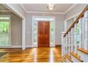 Bright foyer with hardwood floors, decorative ceiling light, and a glimpse of the staircase at 120 Majesty Ln, Fayetteville, GA 30215