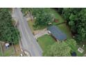 An aerial view of a single-story house with a green lawn, driveway, and surrounding mature trees at 2468 Dresden Ne Dr, Atlanta, GA 30341