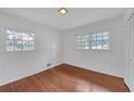 Bright bedroom featuring hardwood floors, ample natural light from two windows, and closet space at 2468 Dresden Ne Dr, Atlanta, GA 30341