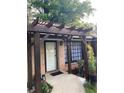 Close-up of the front entrance with a stylish pergola and a well-manicured garden bed at 2468 Dresden Ne Dr, Atlanta, GA 30341