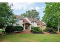 View of the charming home featuring a blend of stucco and stone facade, complemented by a well-manicured lawn at 2917 Ashebrooke Ne Dr, Marietta, GA 30068