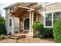 Charming front entrance featuring a covered porch with stone accents, decorative columns, and an iron-detailed front door at 2917 Ashebrooke Ne Dr, Marietta, GA 30068