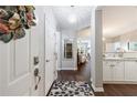 Bright entryway leading into the kitchen and living room, featuring dark hardwood floors at 3150 Woodwalk Se Dr # 2204, Atlanta, GA 30339