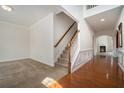 Bright foyer with hardwood floors, a staircase, and an archway leading to the living room at 7761 Parkside Dr, Lithia Springs, GA 30122