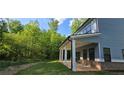 Covered backyard patio with brick accents and multiple columns, perfect for outdoor entertaining at 41 Birch Ct, Mcdonough, GA 30253