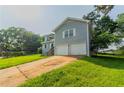 Split-level home with two car garage, attractive siding, and green lawn at 4331 Wrexham Ct, Snellville, GA 30039