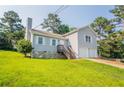 Split-level house with two-car garage, stone accents, and inviting front yard at 4331 Wrexham Ct, Snellville, GA 30039