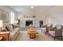 Inviting living room with a cozy fireplace, neutral color palette, and comfortable seating arrangement at 4331 Wrexham Ct, Snellville, GA 30039