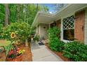 Inviting front entrance with lush landscaping, flower beds, and a charming walkway leading to the front door at 1736 Morris Landers Ne Dr, Atlanta, GA 30345