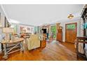 Open-concept living room with hardwood floors, abundant natural light, and vintage furnishings at 1736 Morris Landers Ne Dr, Atlanta, GA 30345