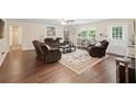 Spacious living room with hardwood floors, plush seating, and ample natural light at 2056 Merle Se Dr, Conyers, GA 30013