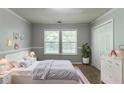 Comfortable bedroom with a serene ambiance, natural light, and ample storage at 7384 Birch Hollow Pl, Douglasville, GA 30134