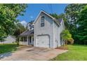 A charming home with a garage, landscaped front yard, and a covered porch, perfect for suburban living at 7384 Birch Hollow Pl, Douglasville, GA 30134