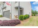 Attractive home exterior featuring an inviting front door and lush landscaping on a sunny day at 739 Woodstock Grove Dr, Woodstock, GA 30188