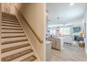 Open layout showcasing the staircase, kitchen island, and a comfortable living room area at 739 Woodstock Grove Dr, Woodstock, GA 30188
