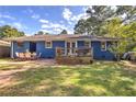 Brick patio with outdoor dining set and a wooden deck in a grassy backyard at 854 Parkway Se Dr, Smyrna, GA 30080