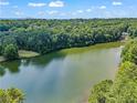 Scenic aerial view showcasing the property's position on a wooded lot with lake access at 1126 Wedgefield Sw Dr, Marietta, GA 30064