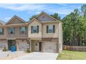 Charming two-story townhome with single-car garage and manicured lawn at 3473 Shoal Oak Ct, Riverdale, GA 30296