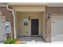 Inviting front entrance with brick accents and attached one-car garage at 3473 Shoal Oak Ct, Riverdale, GA 30296