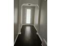 View of the home's arched entryway and dark hardwood floors at 6585 Story Cir, Norcross, GA 30093