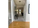 Inviting foyer with hardwood floors transitioning to plush carpet, leading to a cozy living space at 107 Sedgefield Overlook, Dallas, GA 30157