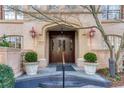 Grand entrance featuring a beautiful arched doorway, decorative sconces, and meticulously maintained landscaping at 1717 N Decatur Ne Rd # 322, Atlanta, GA 30307
