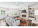Bright living room with a cozy fireplace, custom built-ins, and a large sectional sofa perfect for entertaining at 1717 N Decatur Ne Rd # 322, Atlanta, GA 30307