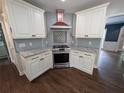 Gourmet kitchen with stainless steel appliances and light blue backsplash at 5882 Grandview Nw Ct, Acworth, GA 30101