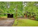 Beautiful home with a carport, surrounded by mature trees and lush greenery providing a serene and private environment at 749 Dogwood Dr, Lawrenceville, GA 30046