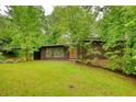 Inviting home exterior featuring a well-kept lawn and mature trees, offering a serene and private setting at 749 Dogwood Dr, Lawrenceville, GA 30046
