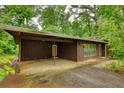 Spacious carport of this home offers ample parking, complemented by well-maintained landscaping at 749 Dogwood Dr, Lawrenceville, GA 30046