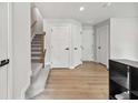 Bright entryway featuring wood floors, staircase and access to multiple rooms at 125 Climbing Ivy Cir, Fayetteville, GA 30214