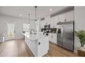 Bright kitchen with white cabinets, stainless steel appliances, and a center island at 125 Climbing Ivy Cir, Fayetteville, GA 30214