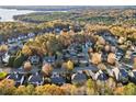 A beautiful aerial view of a neighborhood with mature trees and a lake in the background during the Fall at 424 Lake Point Trce, Canton, GA 30114