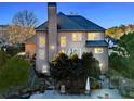 An exterior view of the home with a chimney, back yard, and partial view of the patio at 424 Lake Point Trce, Canton, GA 30114